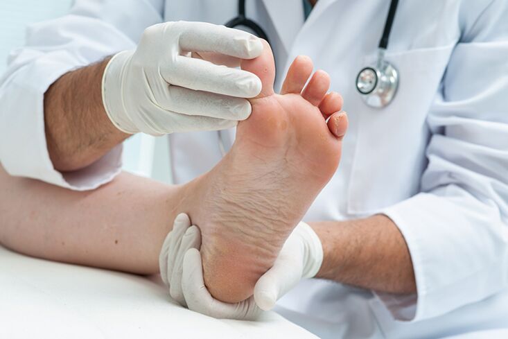 the dermatologist examines the patient's legs